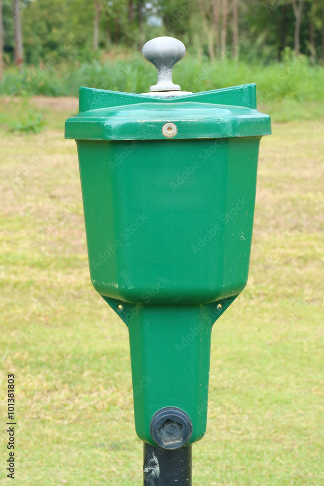 The close-up golf ball washer with green golf course background. The close-up golf ball washer with green golf course background.