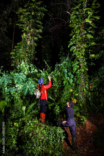 Traveller couple search and explore through tropical rain forest