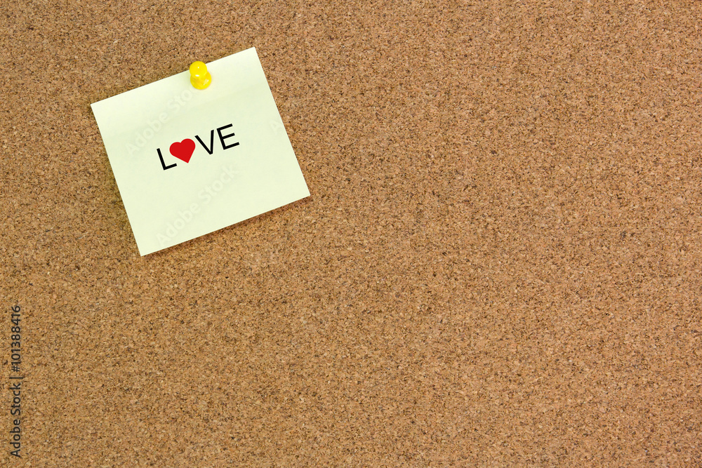Message LOVE and heart icon on Note Paper on cork board. Message LOVE and heart icon on Note Paper on cork board.