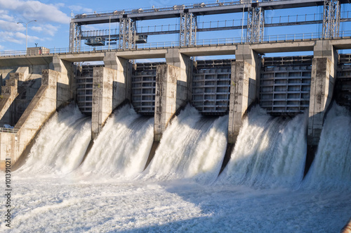 Water rushing out of opened gates of a hydro electric power dam  photo