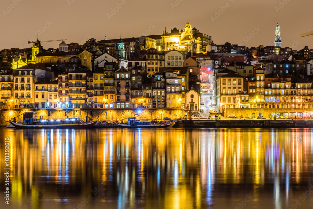 old town cityscape on the Douro River at night, Porto, Portugal.