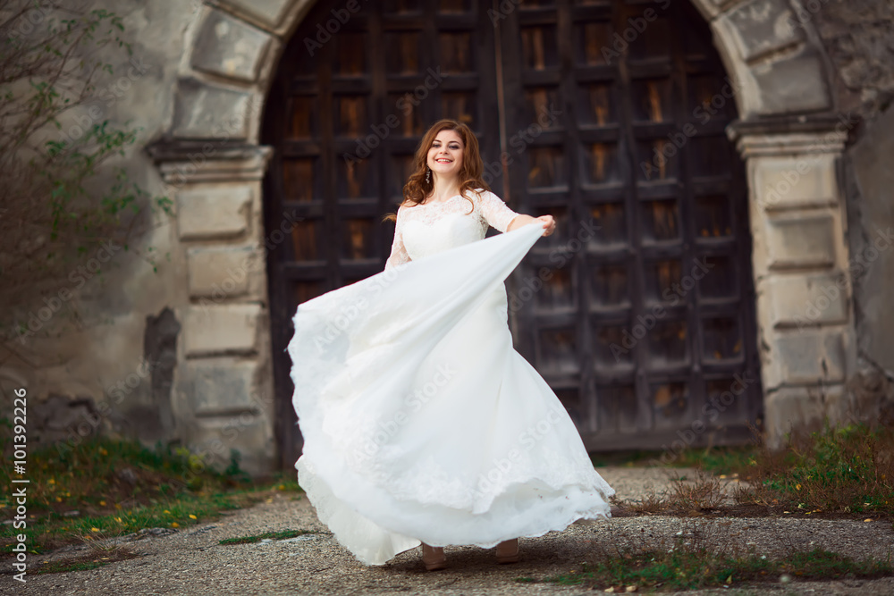 Elegant stylish sweet young beautiful happy bride in amazing wedding dress stands on the old palace. Wedding day Elegant stylish sweet young beautiful happy bride in amazing wedding dress stands on the old palace. Wedding day