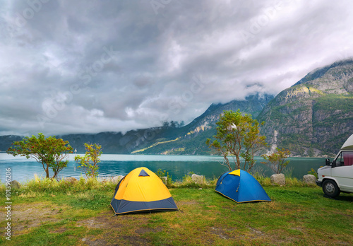  Colorful tourist tents on the shore of the lake. Norway