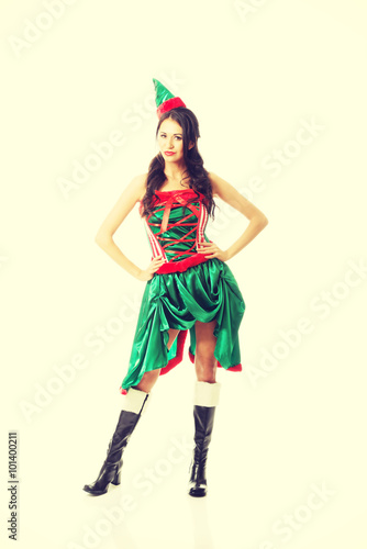 Full length beautiful woman wearing elf clothes, touching her hips
