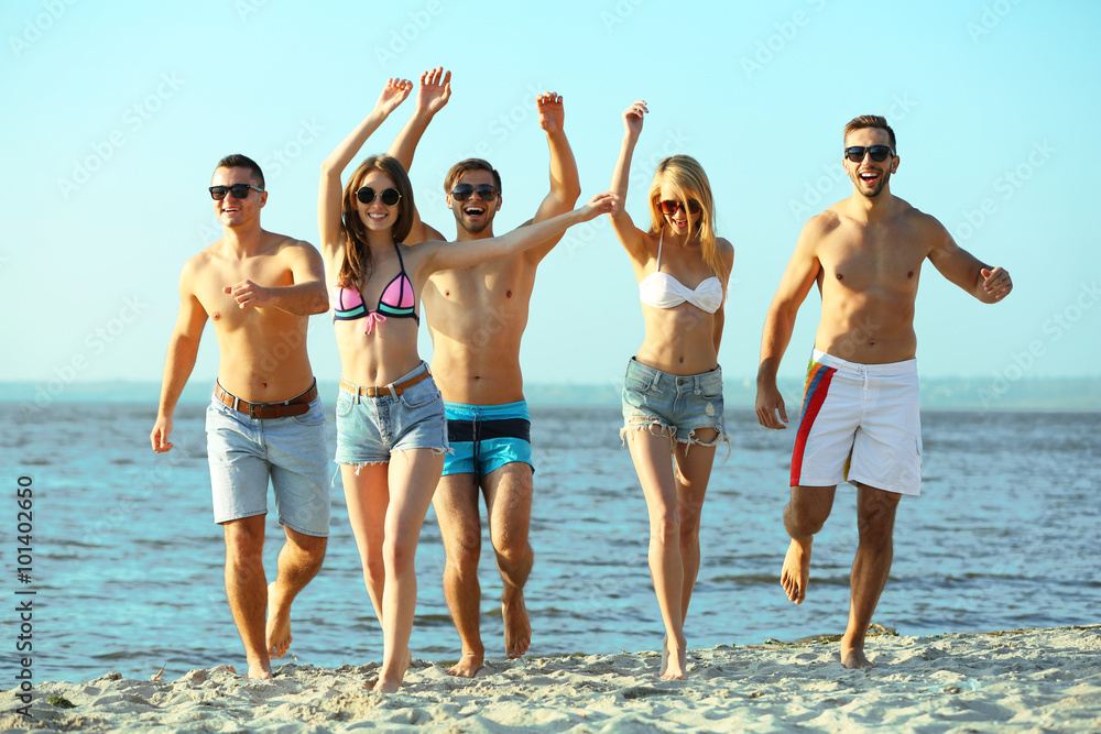 Happy friends running at the beach, outdoors Happy friends running at the beach, outdoors