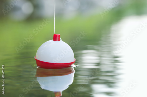 Bobber floating in water with ripples photo