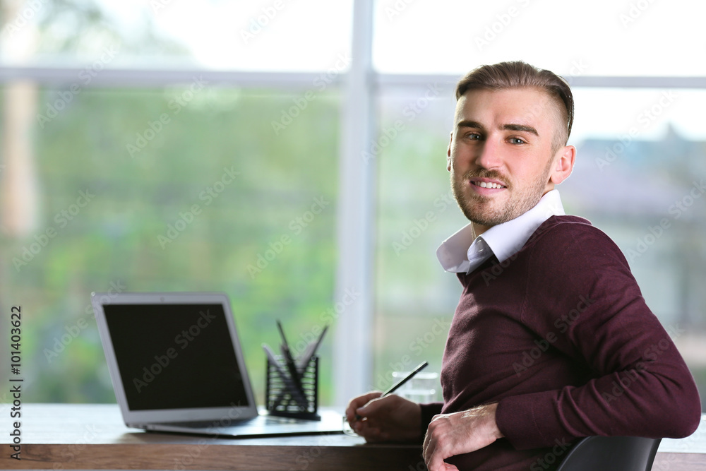 Businessman working with laptop in office