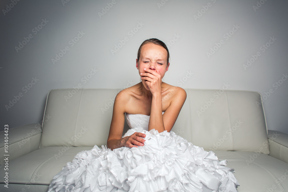 Super tired gorgeous bride sitting on a sofa Super tired gorgeous bride sitting on a sofa