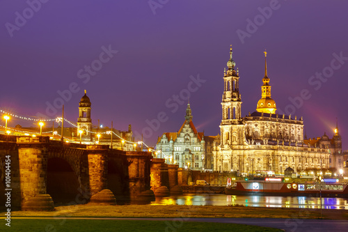 Dresden Cathedral of the Holy Trinity aka Hofkirche Kathedrale Sanctissima Trinitatis and Augustus Bridge with reflections in the river Elbe at night in Dresden, Saxony, Germany