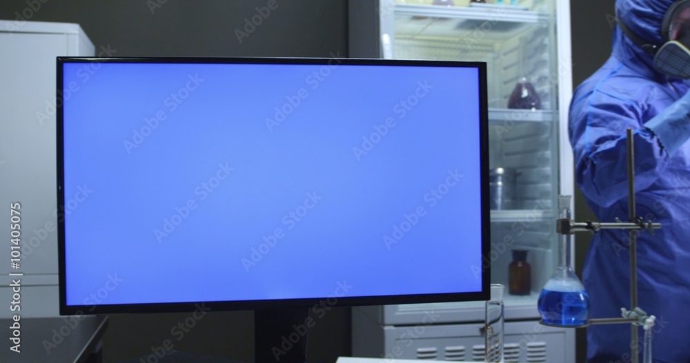 Scientist with protective suit and blue screen Scientist with protective suit and blue screen