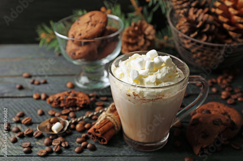 Cup of hot cacao with marshmallow and cookies on black table