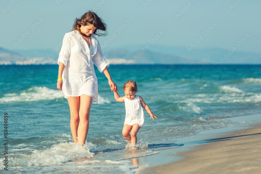 Mother and daughter walking on the beach Mother and daughter walking on the beach