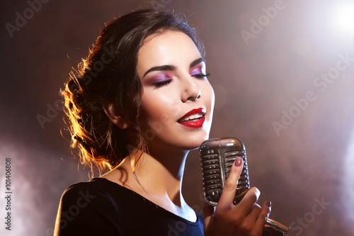 Young pretty woman singing, close up