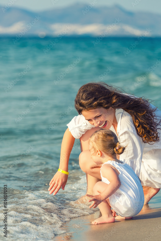 Fototapeta premium Mother and daughter playing on the beach