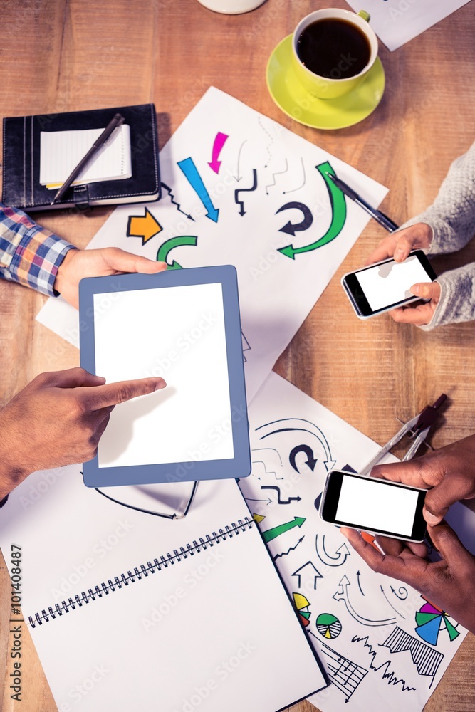 © WavebreakMediaMicro - Overhead view of creative business team working at desk