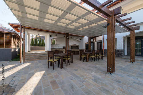 Long table chairs veranda luxury villa exterior