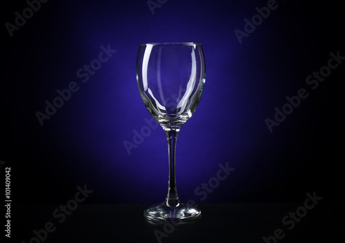 Empty wineglass on dark blue background