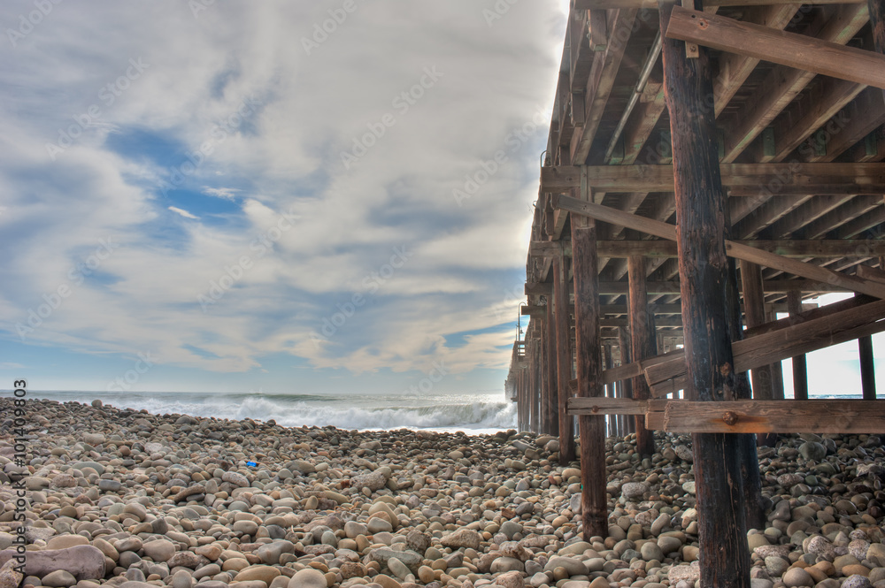 Wooden pier structure holding against the powerful surf. Wooden pier structure holding against the powerful surf.