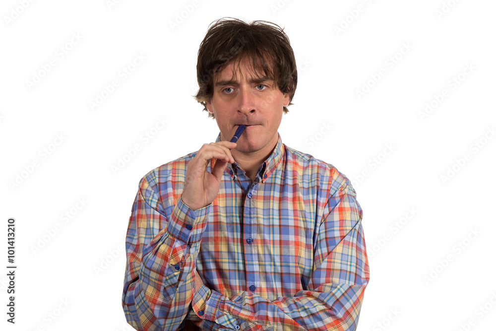 Closeup portrait of pensive young man in checkered shirt with pen Closeup portrait of pensive young man in checkered shirt with pen