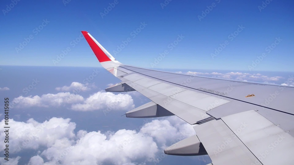Wing of an Airplane Flying Above the Clouds. Wing of an Airplane Flying Above the Clouds.