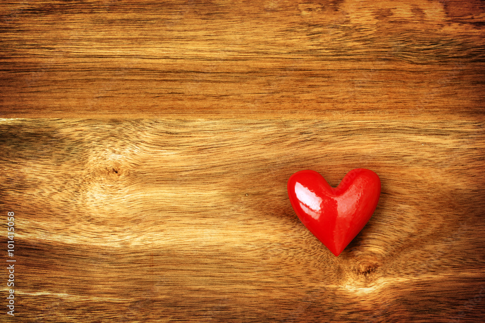 Shiny red heart on wooden background Shiny red heart on wooden background