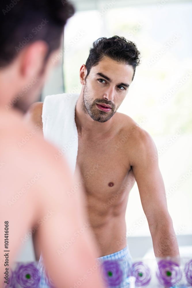 Fototapeta premium Handsome man looking in mirror 