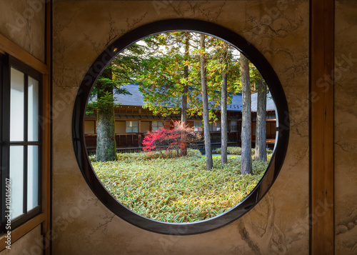 View of a Japanese Garden Through a Round Window photo