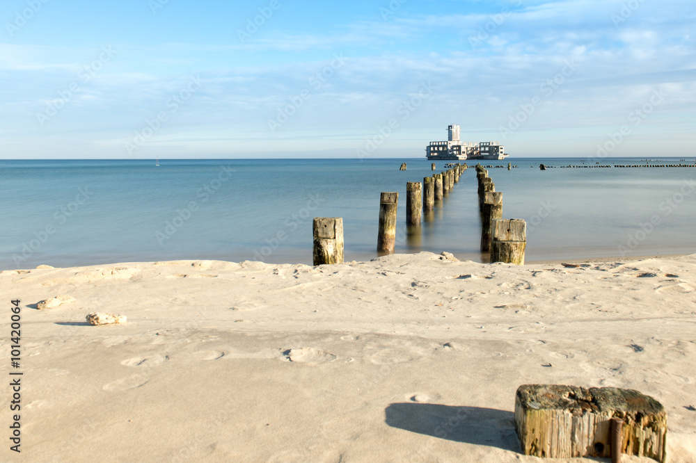 Fototapeta premium Beach in Gdynia at Baltic sea with view on ruins of torpedo from second world`s war.