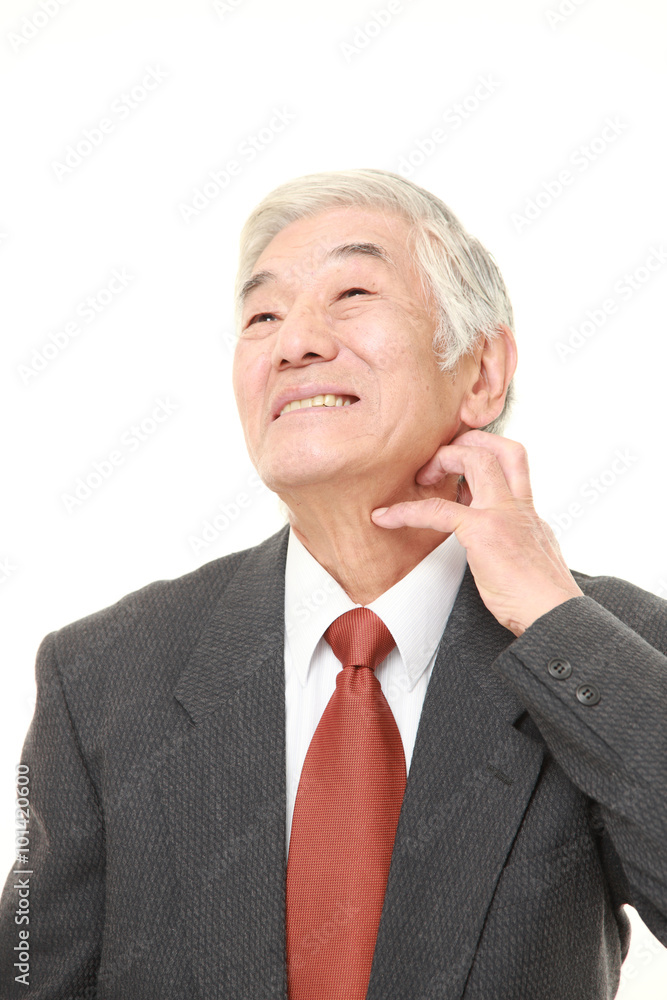 senior Japanese businessman scratching his neck senior Japanese businessman scratching his neck