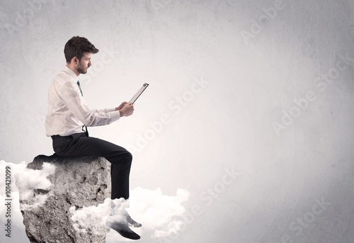 Office worker sitting on top of a rock © ra2 studio