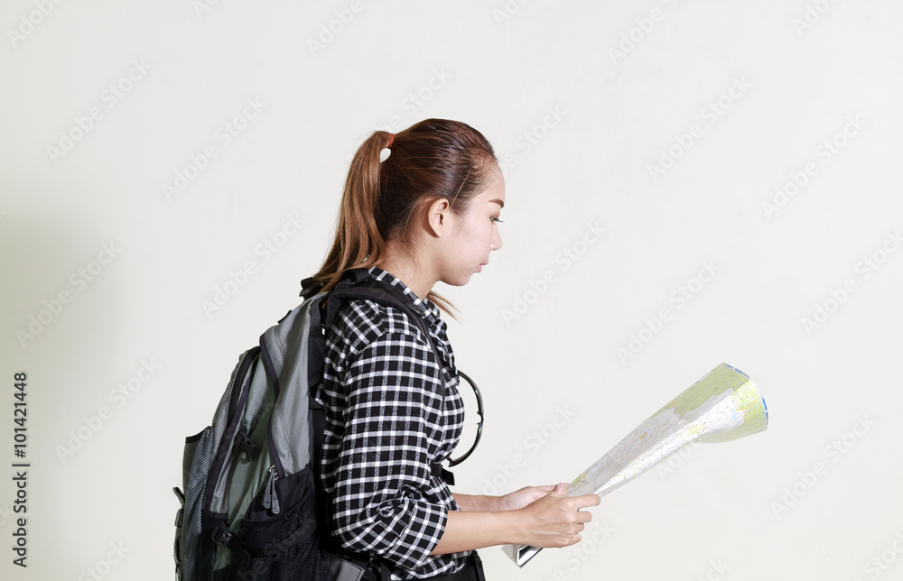 Asian woman carrying a backpack and monitoring tourist map in ha Asian woman carrying a backpack and monitoring tourist map in ha