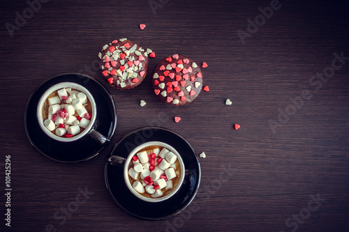 Coffee and cupcakes with small hearts.