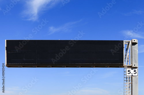 Empty electronic highway sign with blue sky in the background