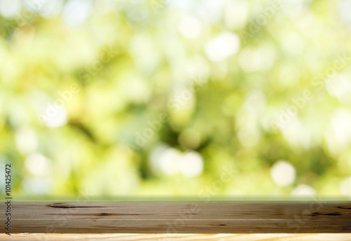 Wood table top on blurred green background