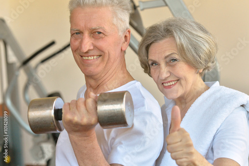 senior couple exercising in gym