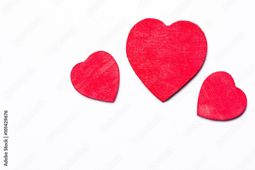 Red wooden heart isolated on white.