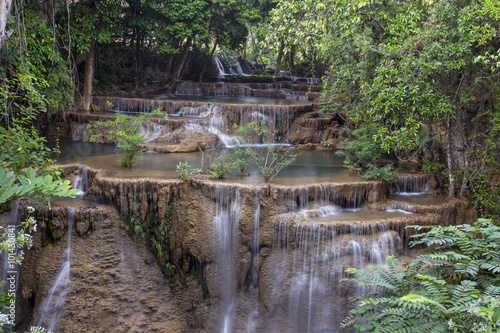 tropical waterfall in deep forest of Kanchanaburi province, Thailand.