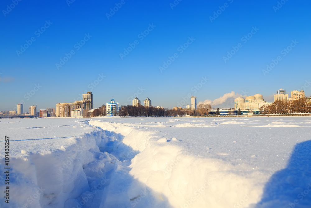View of quay wharf embankment Yekaterinburg City. Winter. Sun