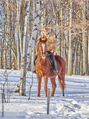 Medieval girl on a horse in the winter