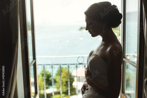 Gorgeous sexy brunette bride posing at balcony at sea resort hot © IVASHstudio