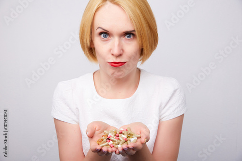 many pills and capsules in women in the hands