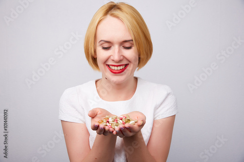 many pills and capsules in women in the hands
