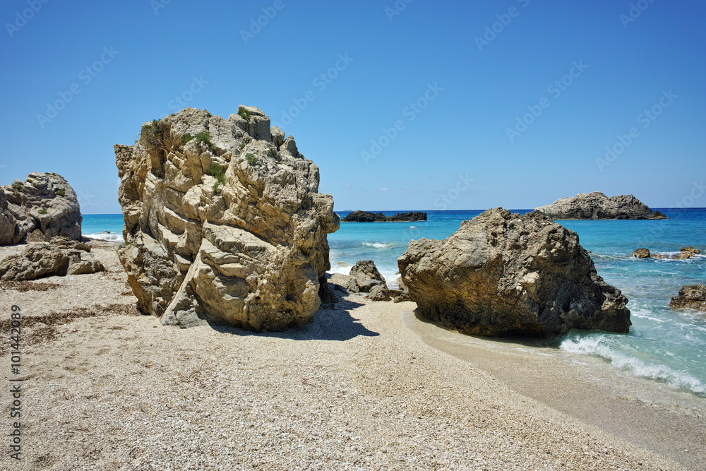 Stones over the sand of Megali Petra, Lefkada, Ionian Islands, Greece Stones over the sand of Megali Petra, Lefkada, Ionian Islands, Greece