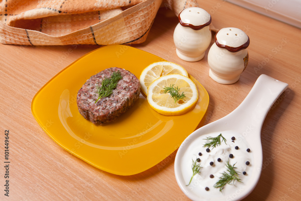raw cutlets with lemon slices on a cutting board raw cutlets with lemon slices on a cutting board
