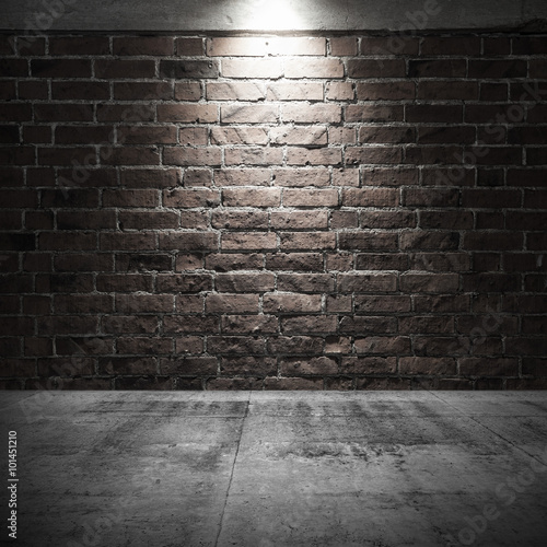 Concrete floor and brick wall with spot light illumination