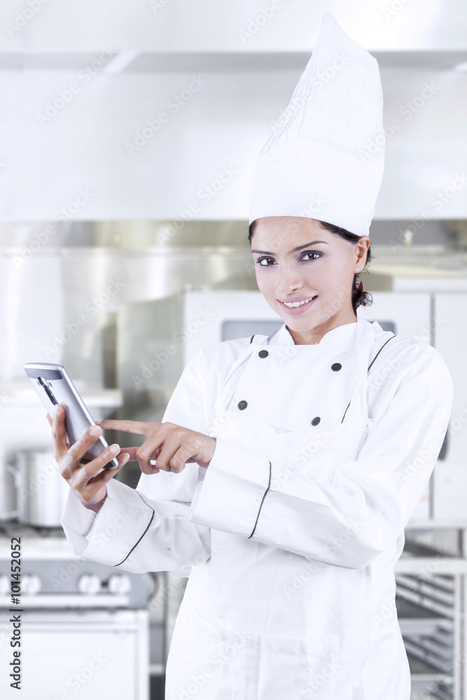 Chef searching menu with cellphone Chef searching menu with cellphone
