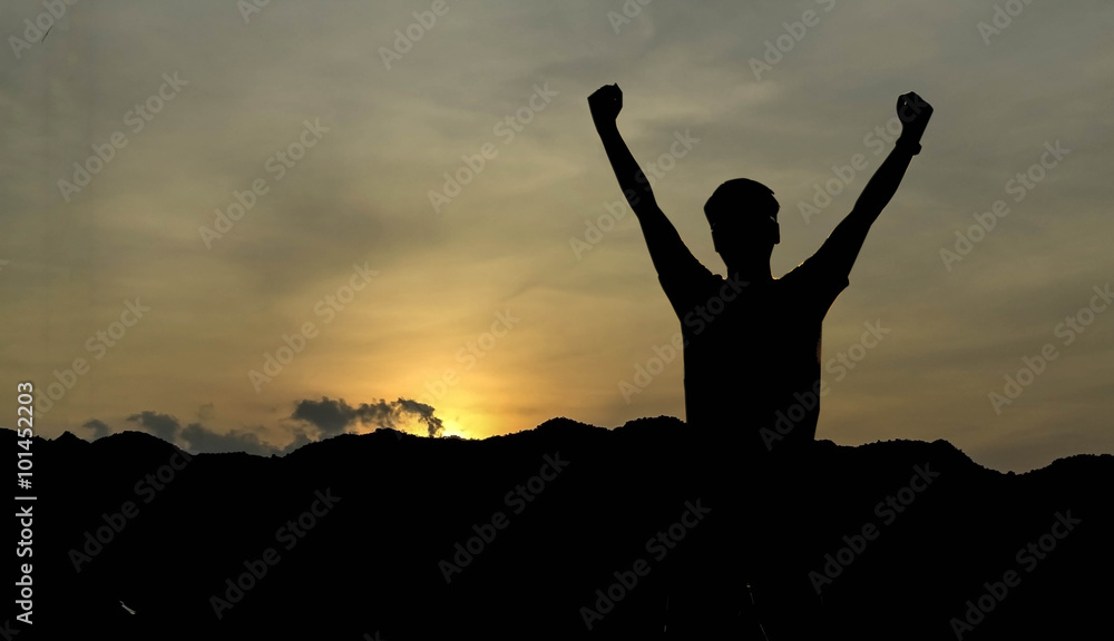 silhouette of man show arm up for achievements successful and celebrating success with sunrise