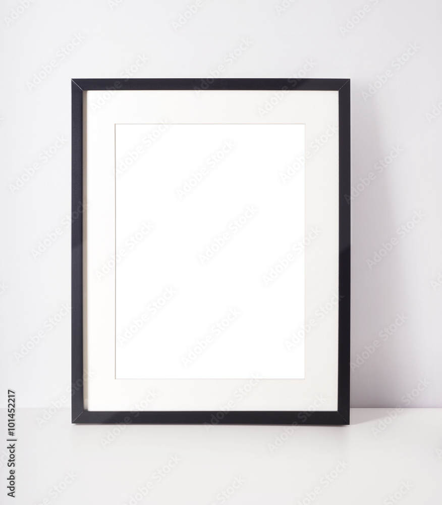 Empty picture frame on white desk - obrazy, fototapety, plakaty 