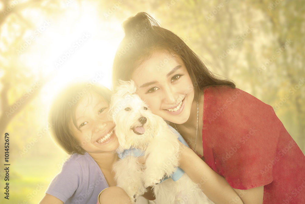 Happy girl and mother with dog at the park Happy girl and mother with dog at the park