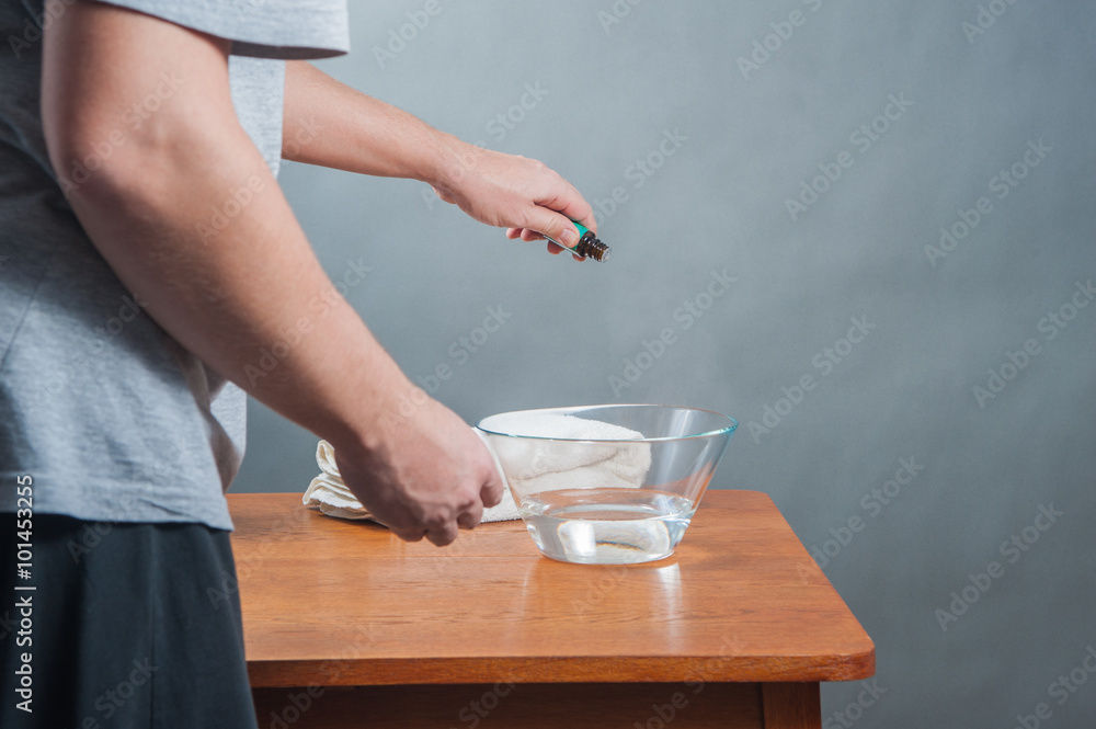 inhalation / The man doing inhalation above bowl on a table at home. inhalation / The man doing inhalation above bowl on a table at home.